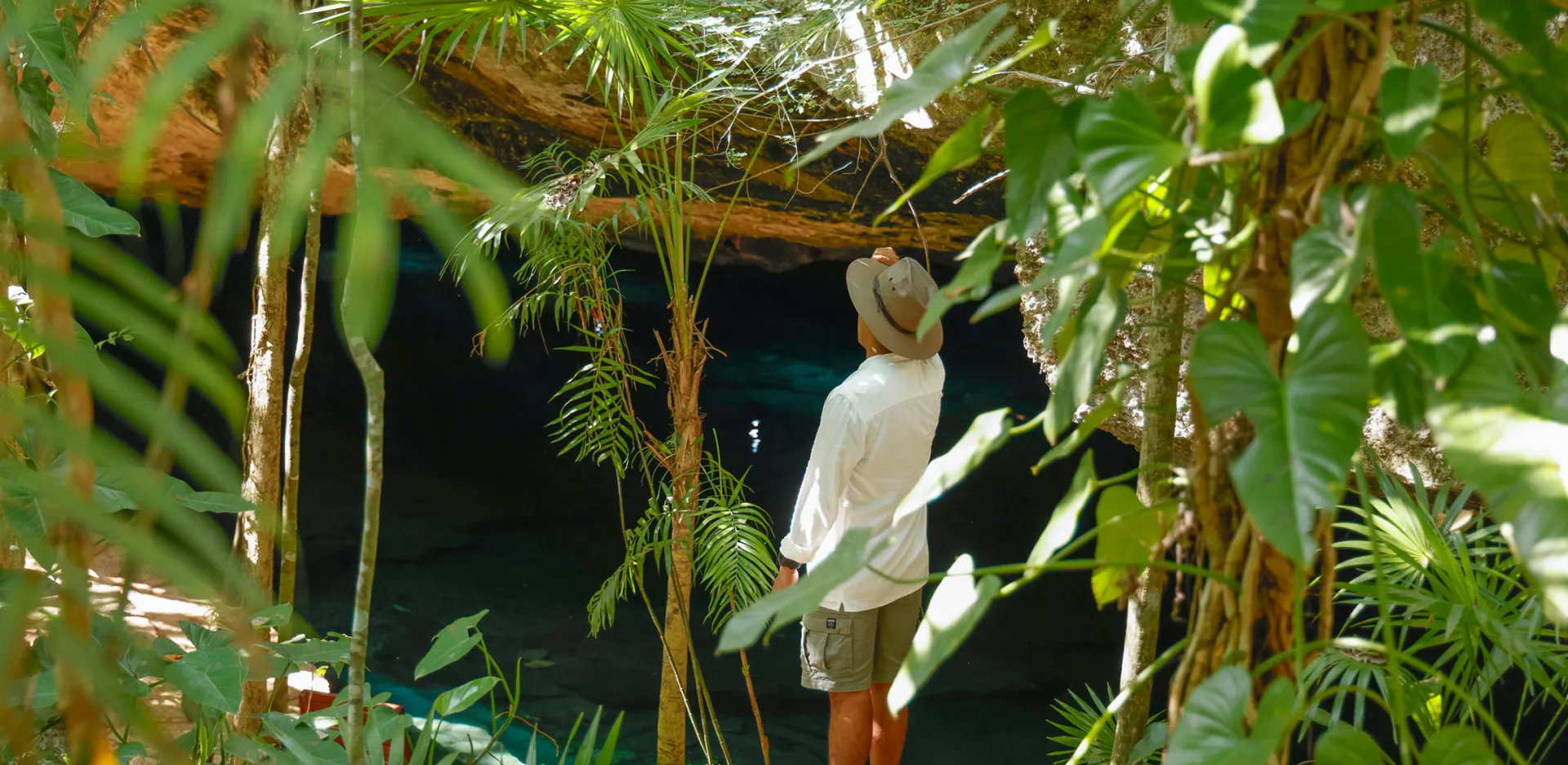 Man exploring the Maya jungle at Kantun Chi