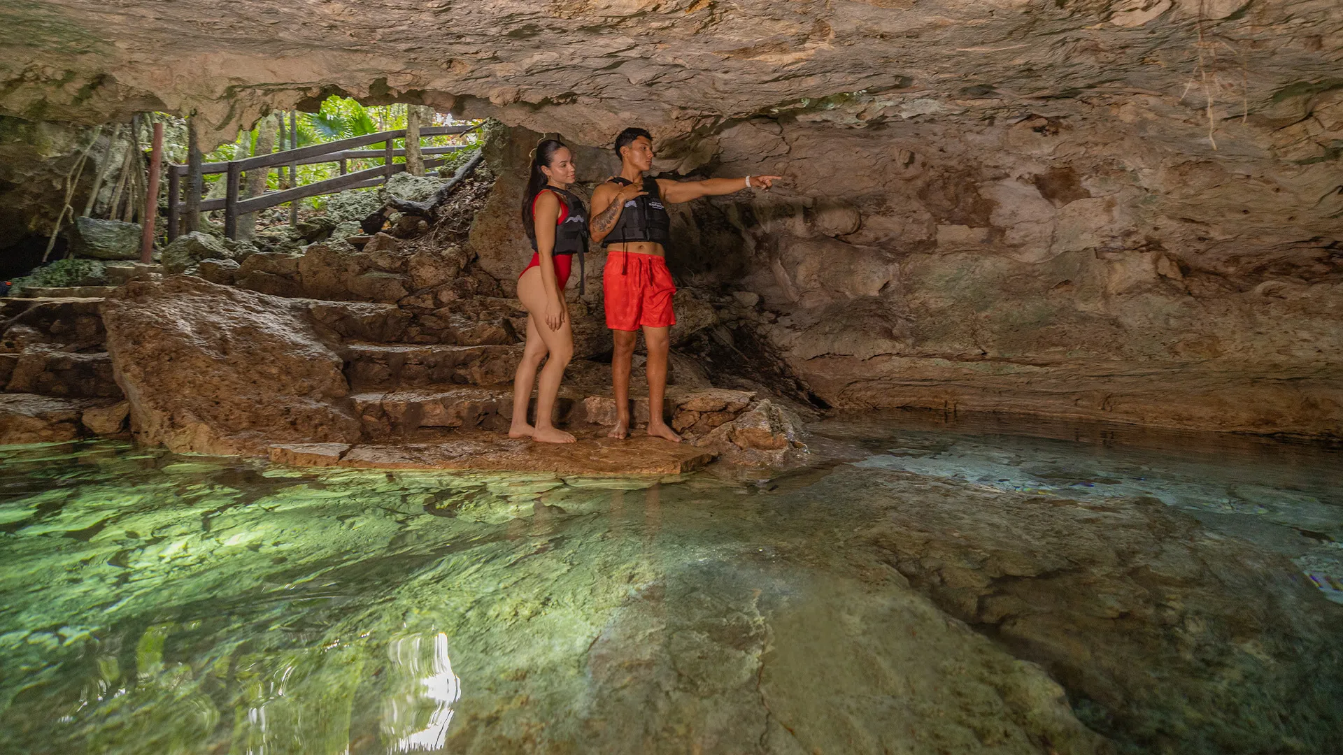 Man swimming in a cenote at Kantun Chi
